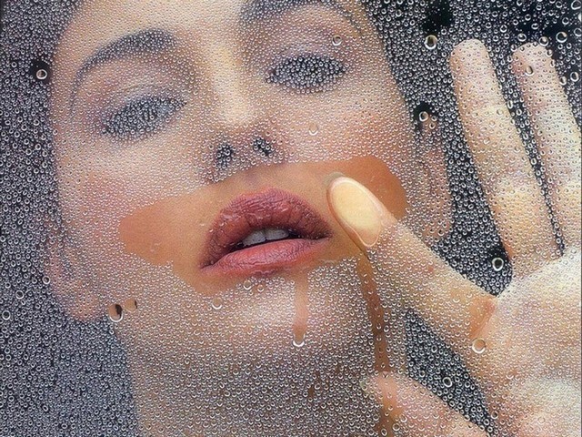 Monica Bellucci Cleaning Moistured Glass